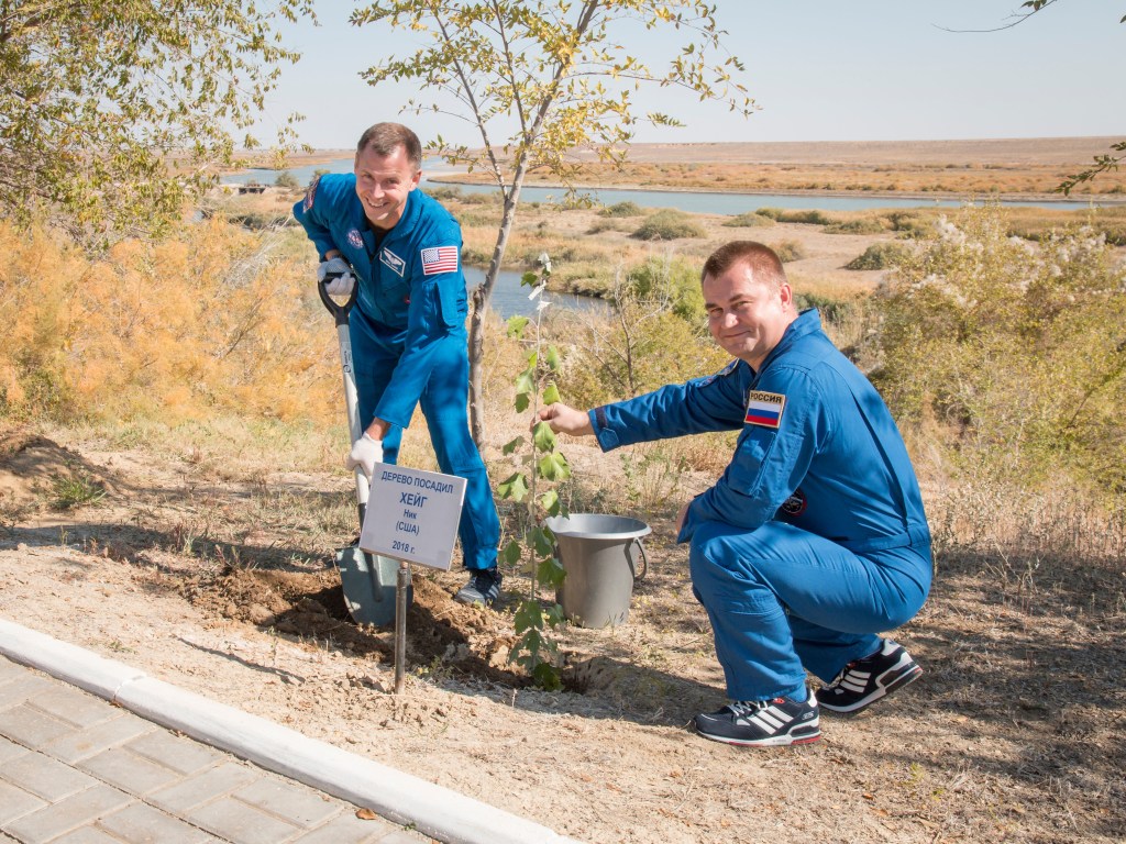 Expedition 57 crew member Nick Hague of NASA, left, plants a tree in his name as part of the traditional pre-launch activities for a first-time flier with help from crewmate Alexey Ovchinin of Roscosmos, Wednesday, Oct. 3, 2018 at the Cosmonaut Hotel in Baikonur, Kazakhstan. Hague and Ovchinin are scheduled to launch on Oct. 11 onboard the Soyuz MS-10 spacecraft from the Baikonur Cosmodrome in Kazakhstan for a six-month mission on the International Space Station.