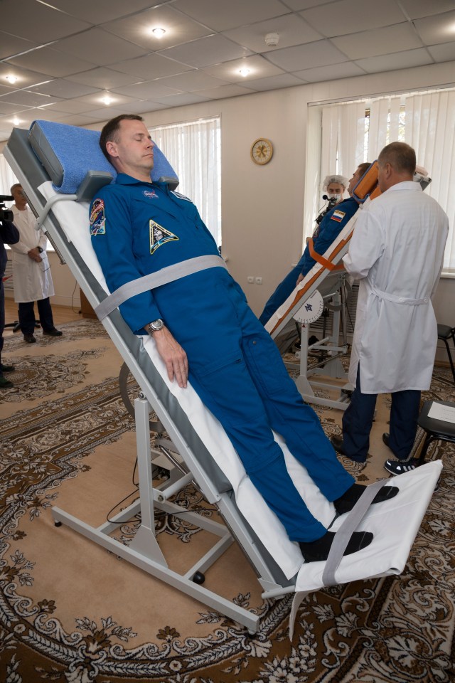 Expedition 57 crew members Nick Hague of NASA, left, and Alexey Ovchinin of Roscosmos, right, conduct tests of their vestibular systems on tilt tables, Wednesday, Oct. 3, 2018 at the Cosmonaut Hotel in Baikonur, Kazakhstan. Hague and Ovchinin are scheduled to launch on Oct. 11 onboard the Soyuz MS-10 spacecraft from the Baikonur Cosmodrome in Kazakhstan for a six-month mission on the International Space Station.