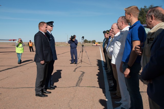 Expedition 57 crew members Alexey Ovchinin of Roscosmos (foreground) and Nick Hague of NASA report to Russian space officials Sept. 25 upon arriving at their launch site in Baikonur, Kazakhstan for final pre-launch training after a flight from their training base in Star City, Russia. Hague and Ovchinin will launch Oct. 11 from the Baikonur Cosmodrome in Kazakhstan on the Soyuz MS-10 spacecraft for a six-month mission on the International Space Station.