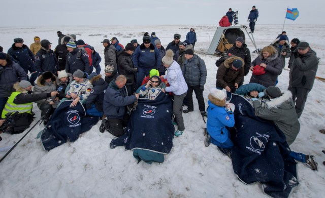 Expedition 57 crew members Alexander Gerst of ESA (European Space Agency), left, Sergey Prokopyev of Roscosmos, center, and Serena Auñón-Chancellor of NASA sit in chairs outside the Soyuz MS-09 spacecraft after they landed in a remote area near the town of Zhezkazgan, Kazakhstan on Thursday, Dec. 20, 2018. Auñón-Chancellor, Gerst and Prokopyev are returning after 197 days in space where they served as members of the Expedition 56 and 57 crews onboard the International Space Station.