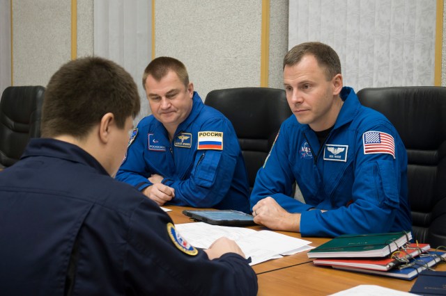 Expedition 57 crew members Alexey Ovchinin of Roscosmos, left, and Nick Hague of NASA, right, review training documents with a Gagarin Cosmonaut Training Center instructor as they prepare for their upcoming launch, Wednesday, Oct. 3, 2018 at the Cosmonaut Hotel in Baikonur, Kazakhstan. Ovchinin and Hague are scheduled to launch on Oct. 11 onboard the Soyuz MS-10 spacecraft from the Baikonur Cosmodrome in Kazakhstan for a six-month mission on the International Space Station.