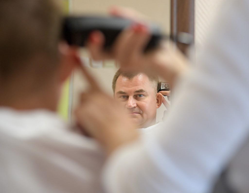 Expedition 57 Flight Engineer Alexey Ovchinin of Roscosmos gets his hair cut, Tuesday, Oct. 9, 2018 at the Cosmonaut Hotel in Baikonur, Kazakhstan. Ovchinin and Expedition 57 Flight Engineer Nick Hague of NASA are scheduled to launch onboard a Soyuz rocket October 11 and will spend the next six months living and working aboard the International Space Station.