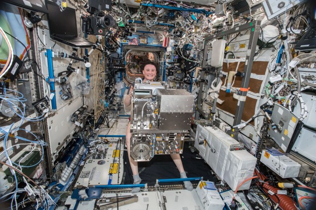 Expedition 57 Flight Engineer Serena Auñón-Chancellor of NASA holds an Air and Water Management Drawer removed from a Life Support Rack inside the U.S. Destiny laboratory during maintenance work aboard the International Space Station.