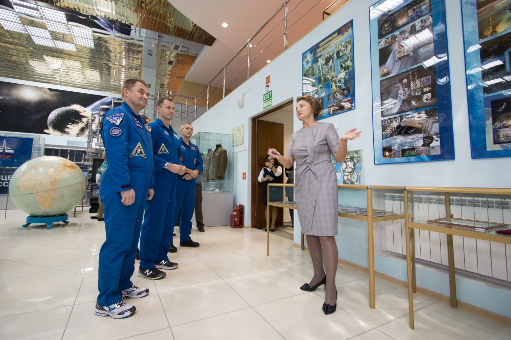 At the Baikonur Cosmodrome Museum in Kazakhstan, Expedition 57 prime crewmembers Alexey Ovchinin of Roscosmos (left) and Nick Hague of NASA (center) and backup crewmember David Saint-Jacques of the Canadian Space Agency (right) receive a briefing Oct. 6 on some of the artifacts housed in the facility during traditional pre-launch activities. Hague and Ovchinin will launch Oct. 11 from the Baikonur Cosmodrome on the Soyuz MS-10 spacecraft for a six-month mission on the International Space Station.