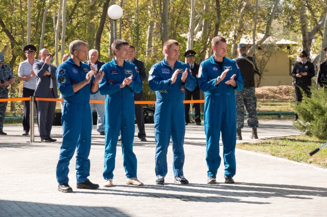 At their Cosmonaut Hotel crew quarters in Baikonur, Kazakhstan, the Expedition 57 prime and backup crew members applaud during traditional pre-launch flag raising ceremonies Sept. 27. From left to right are backup crew members David Saint-Jacques of the Canadian Space Agency and Oleg Kononenko of Roscosmos and prime crew members Alexey Ovchinin of Roscosmos and Nick Hague of NASA. Ovchinin and Hague of will launch Oct. 11 on the Soyuz MS-10 spacecraft from the Baikonur Cosmodrome in Kazakhstan for a six-month mission on the International Space Station.