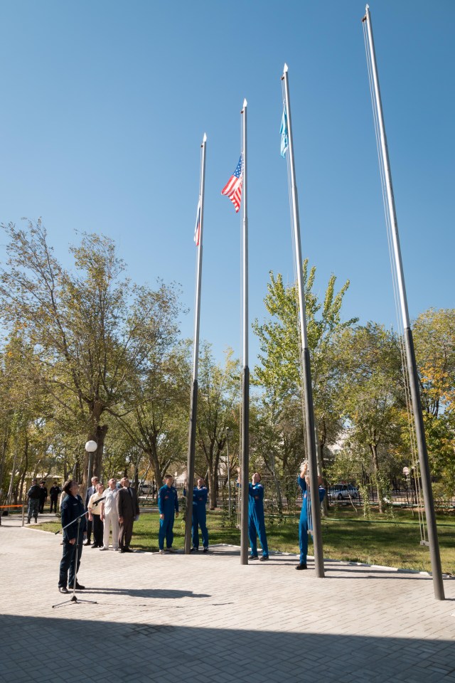 At their Cosmonaut Hotel crew quarters in Baikonur, Kazakhstan, the Expedition 57 prime and backup crew members raise the flags of Russia, the United States and Kazakhstan Sept. 27 in traditional pre-launch ceremonies. Alexey Ovchinin of Roscosmos and Nick Hague of NASA will launch Oct. 11 on the Soyuz MS-10 spacecraft from the Baikonur Cosmodrome in Kazakhstan for a six-month mission on the International Space Station.