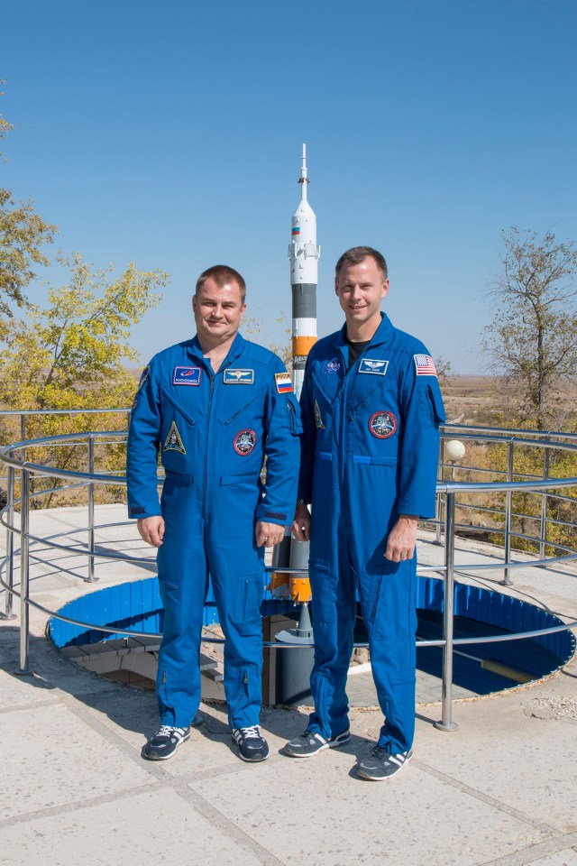 Expedition 57 prime crew members Alexey Ovchinin of Roscosmos, left, and Nick Hague of NASA, right, pose for pictures in front of a model of a Soyuz rocket, Wednesday, Oct. 3, 2018 at the Cosmonaut Hotel crew quarters in Baikonur, Kazakhstan. Ovchinin and Hague are scheduled to launch on Oct. 11 onboard the Soyuz MS-10 spacecraft from the Baikonur Cosmodrome in Kazakhstan for a six-month mission on the International Space Station.