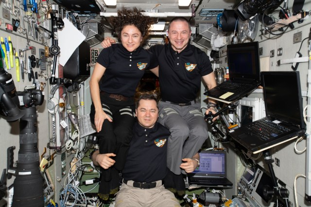 iss062e014051 (Feb. 15, 2020) --- Expedition 62 Commander and Roscosmos cosmonaut Oleg Skripochka poses with NASA Flight Engineers Jessica Meir and Andrew Morgan perched on his shoulders in the weightless environment of the International Space Station's Zvezda service module.