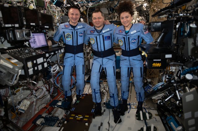 iss062e116029 (March 29, 2020) --- NASA Flight Engineers Andrew Morgan and Jessica Meir flank Expedition 62 Commander Oleg Skripochka of Roscosmos for a portrait in the weightless environment of the International Space Station.
