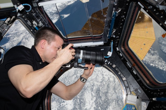 iss062e147835 (April 12, 2020) --- NASA astronaut and Expedition 62 Flight Engineer Andrew Morgan photographs the Earth below from inside the International Space Station's "window to the world," the cupola. The orbiting lab was flying above Lake Huron in North America at the time this photograph was taken.