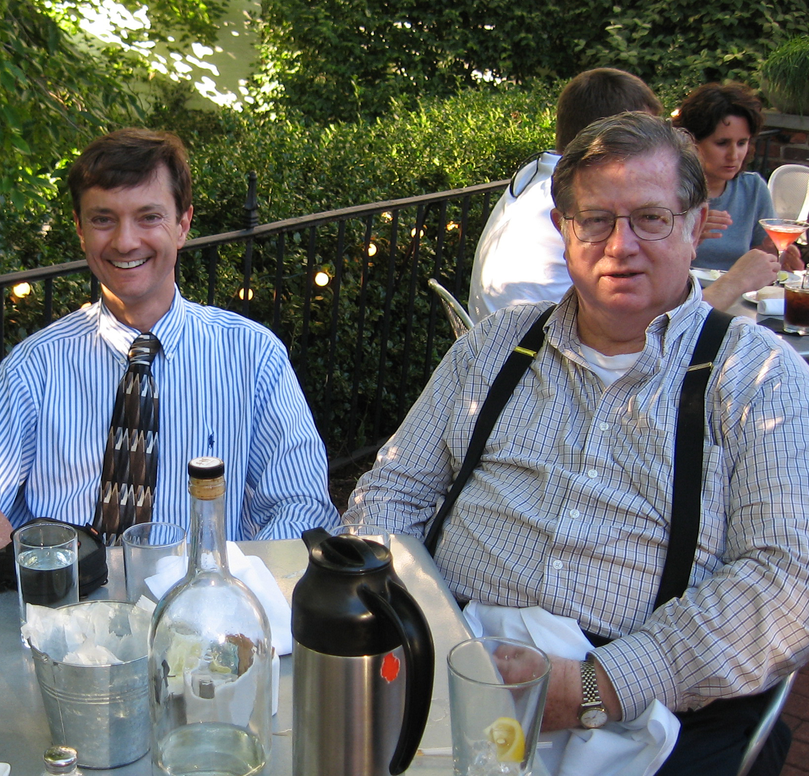 Two men seated at table.