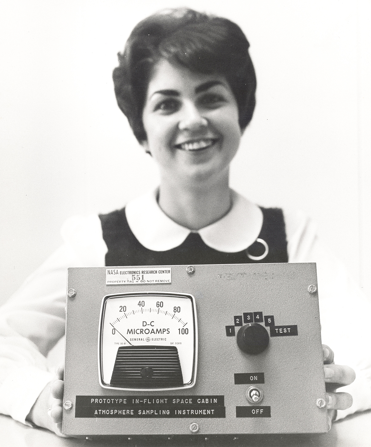 Woman holding sampling instrument.