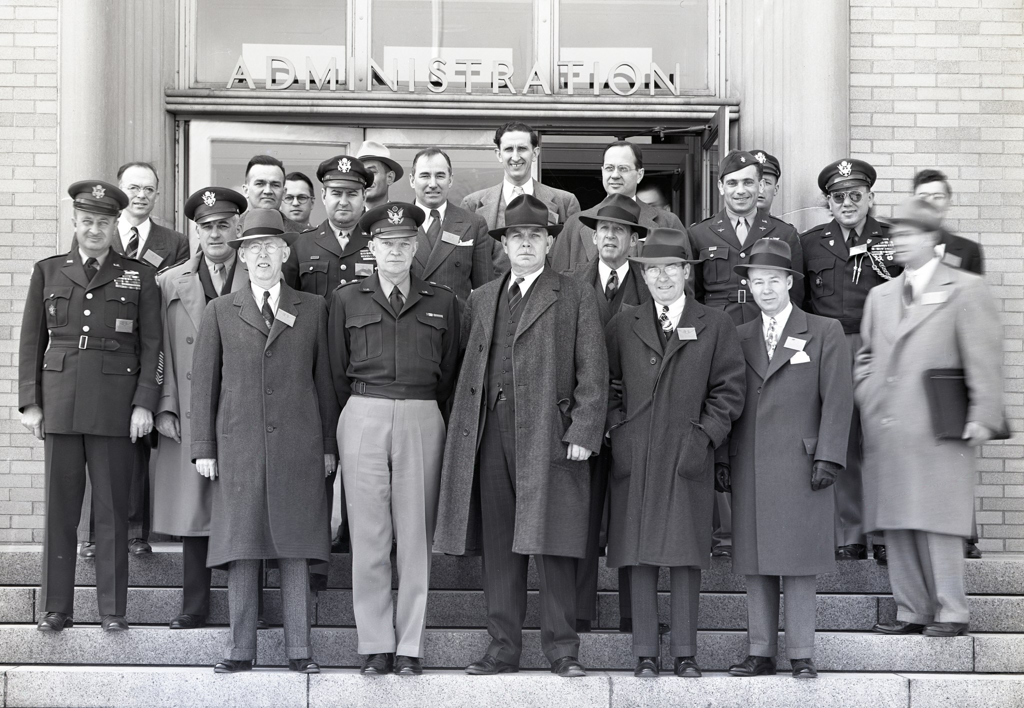 Group of people posing outside of building.