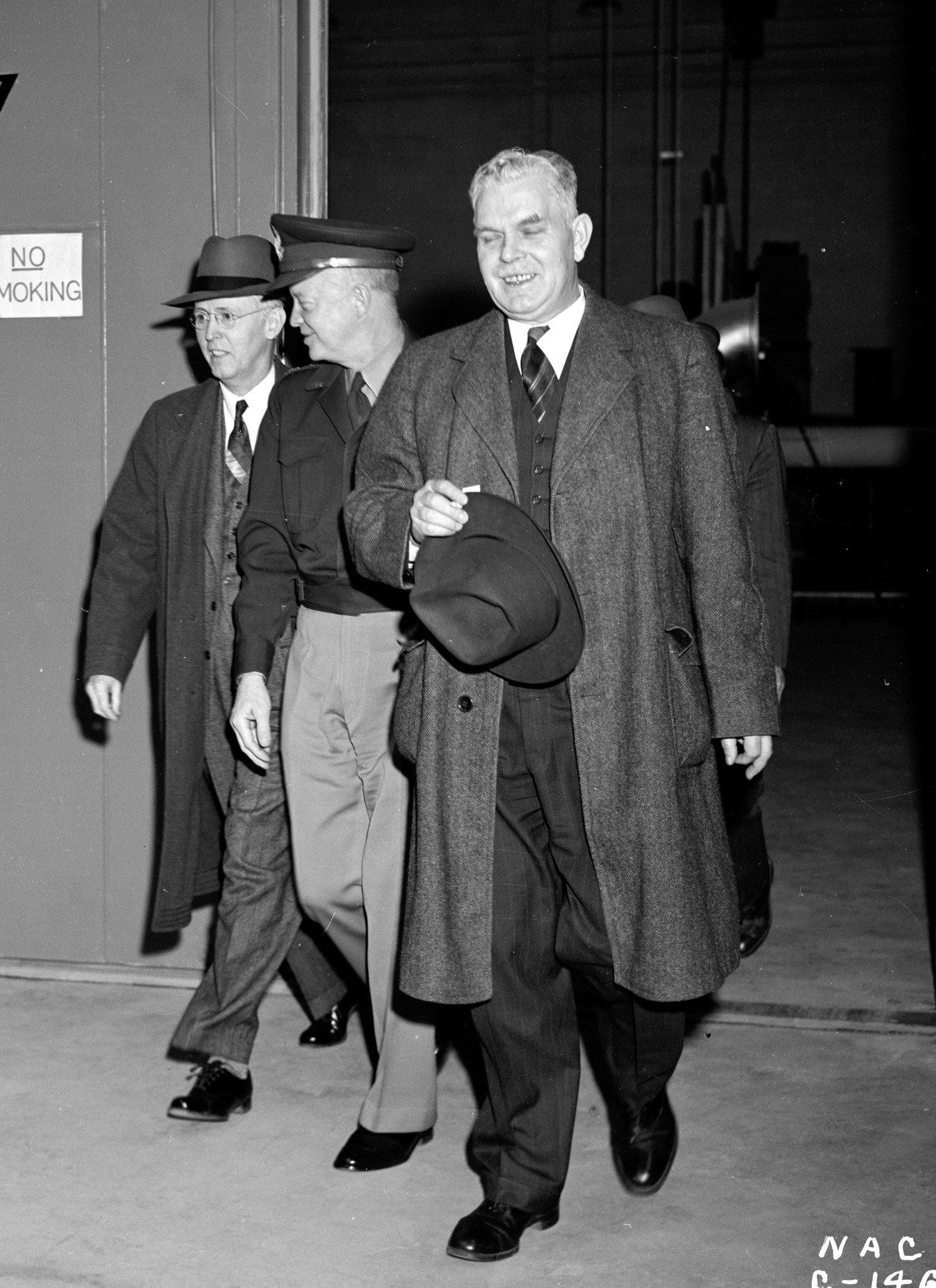 Three men exiting building.