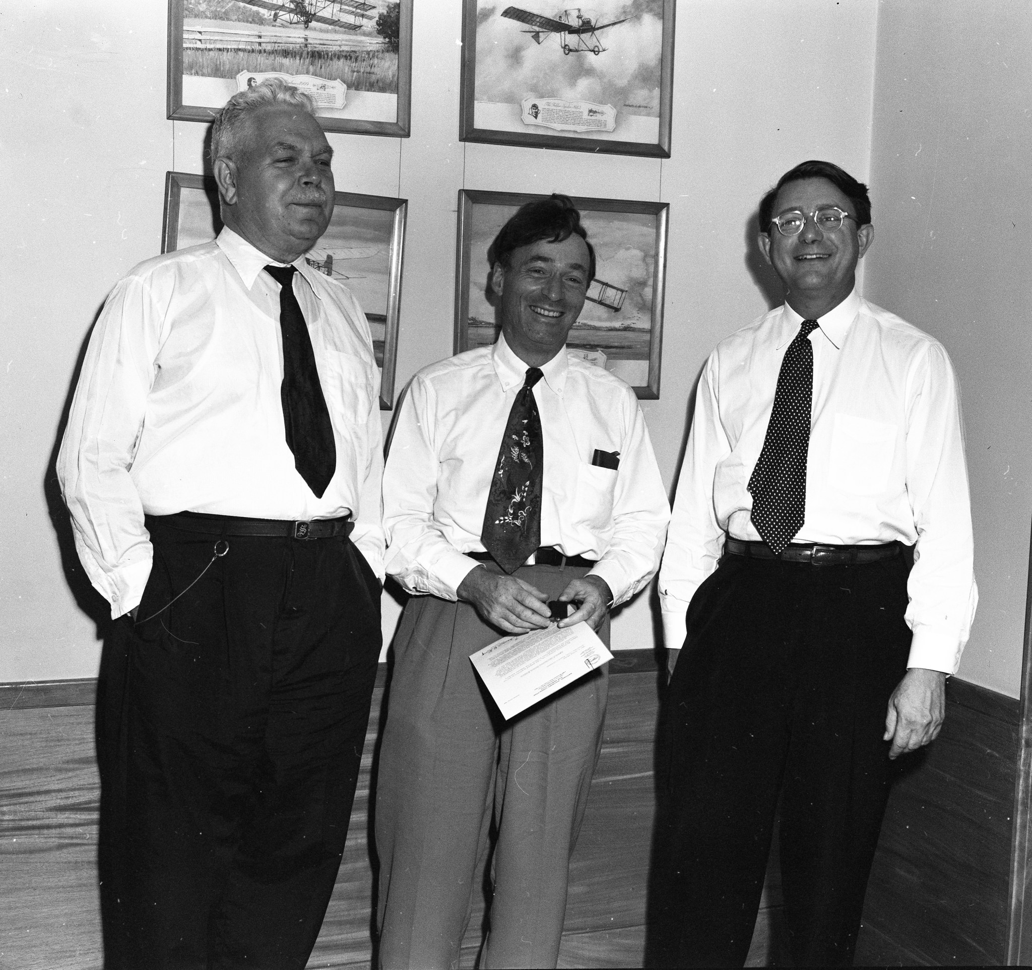 Three men standing.