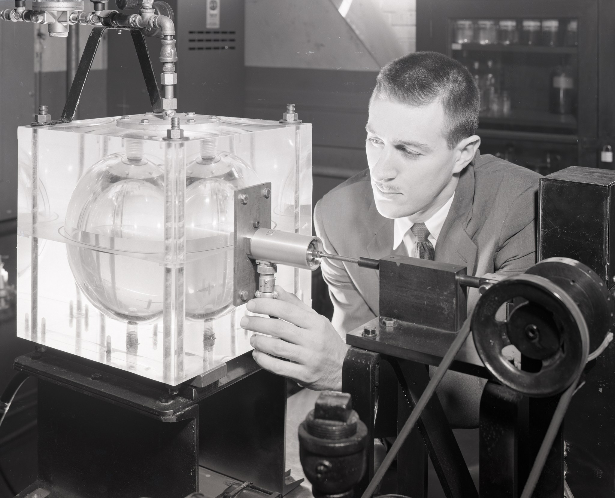 Man looking at spherical tank.