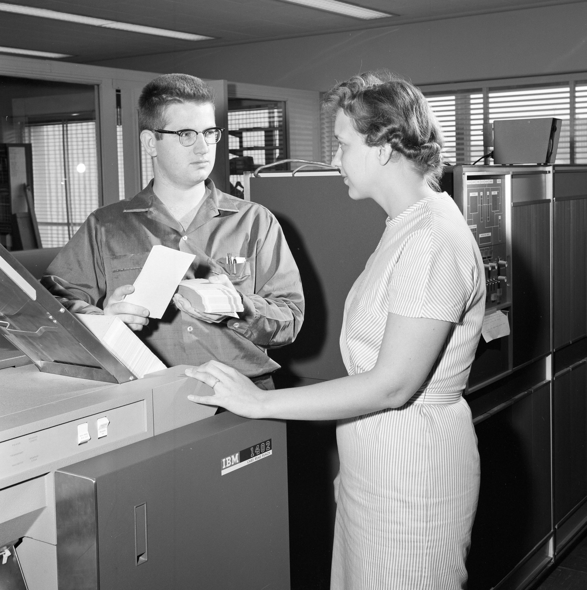 Man and woman working with computer equipment.
