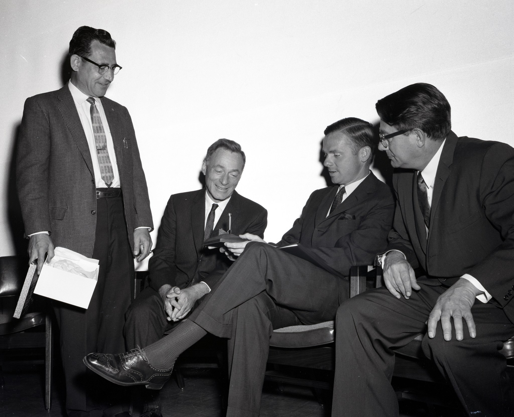 Men seated at table.