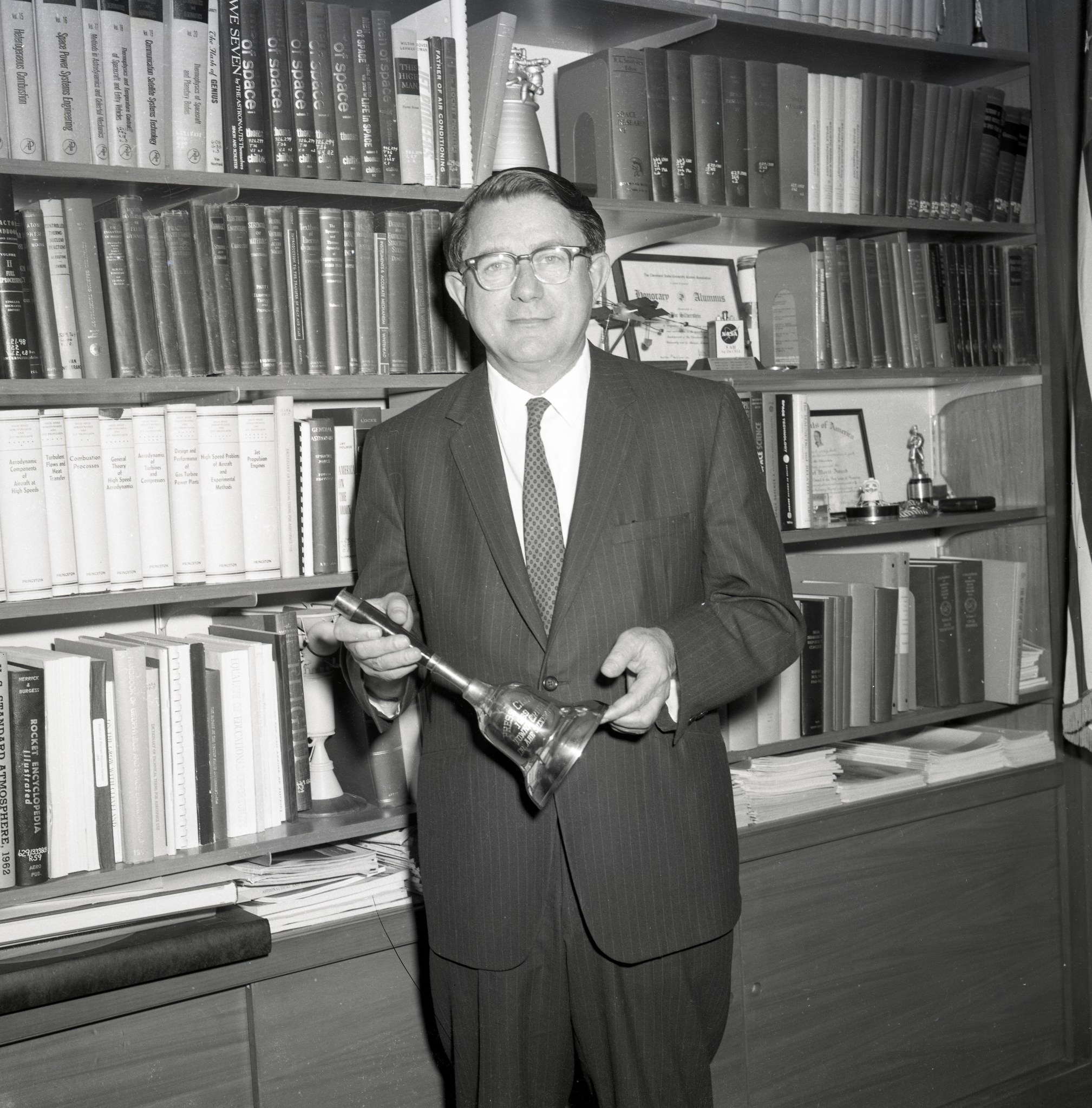 Man standing in front of bookcase.