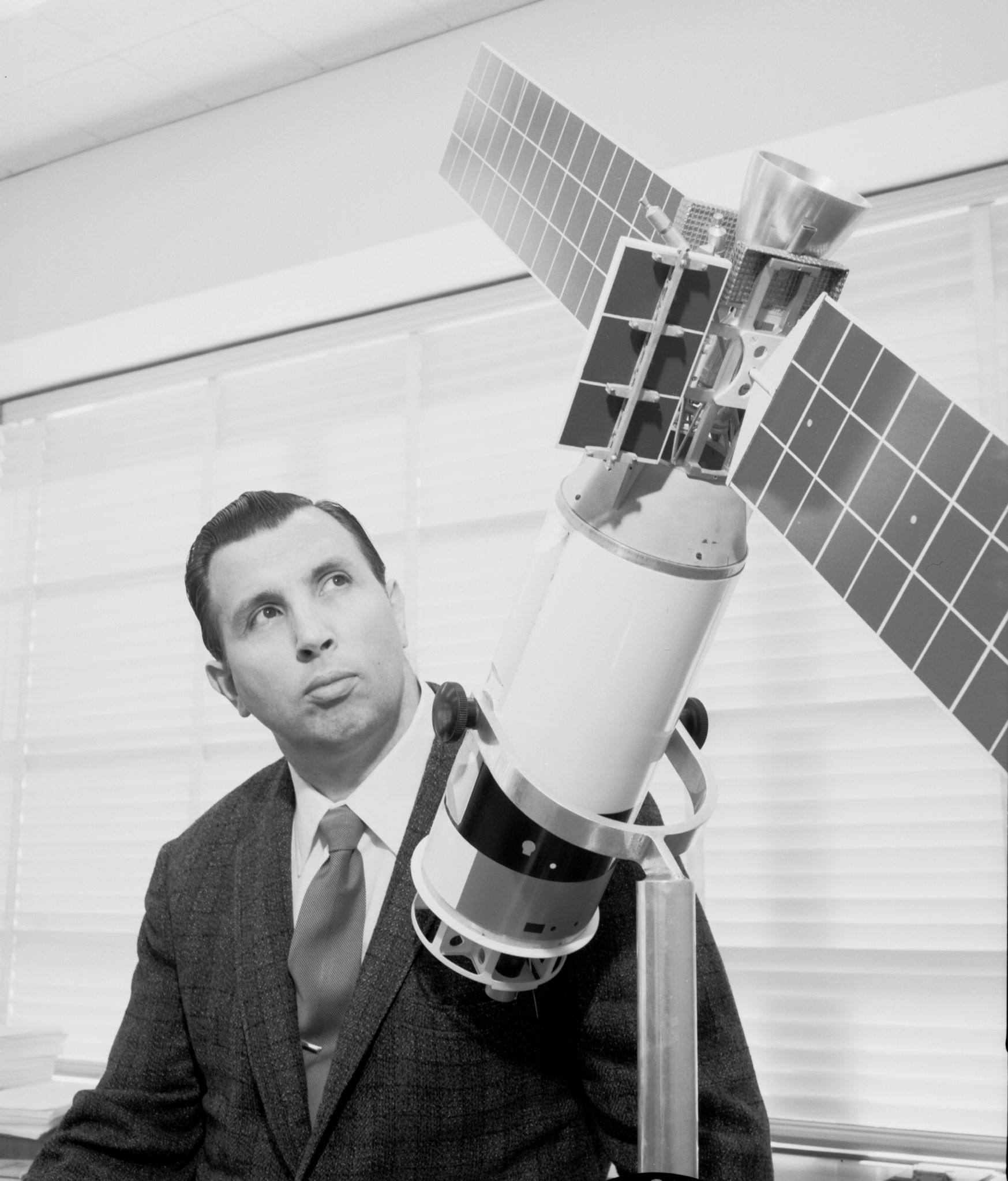 Man with spacecraft model.