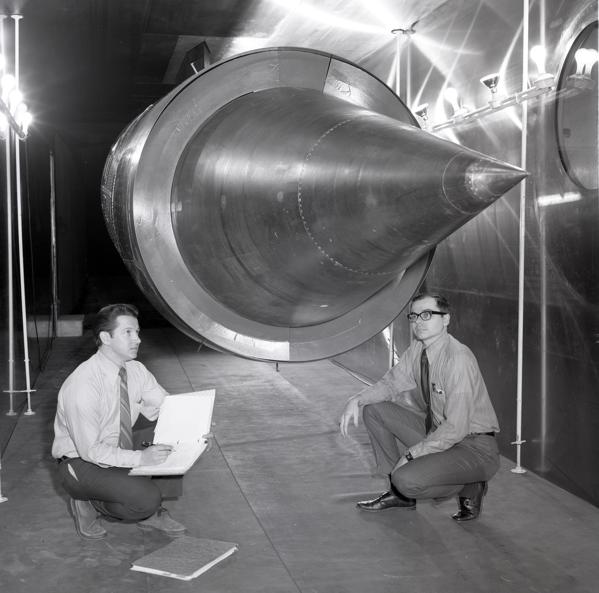 Two men with large inlet in test section.