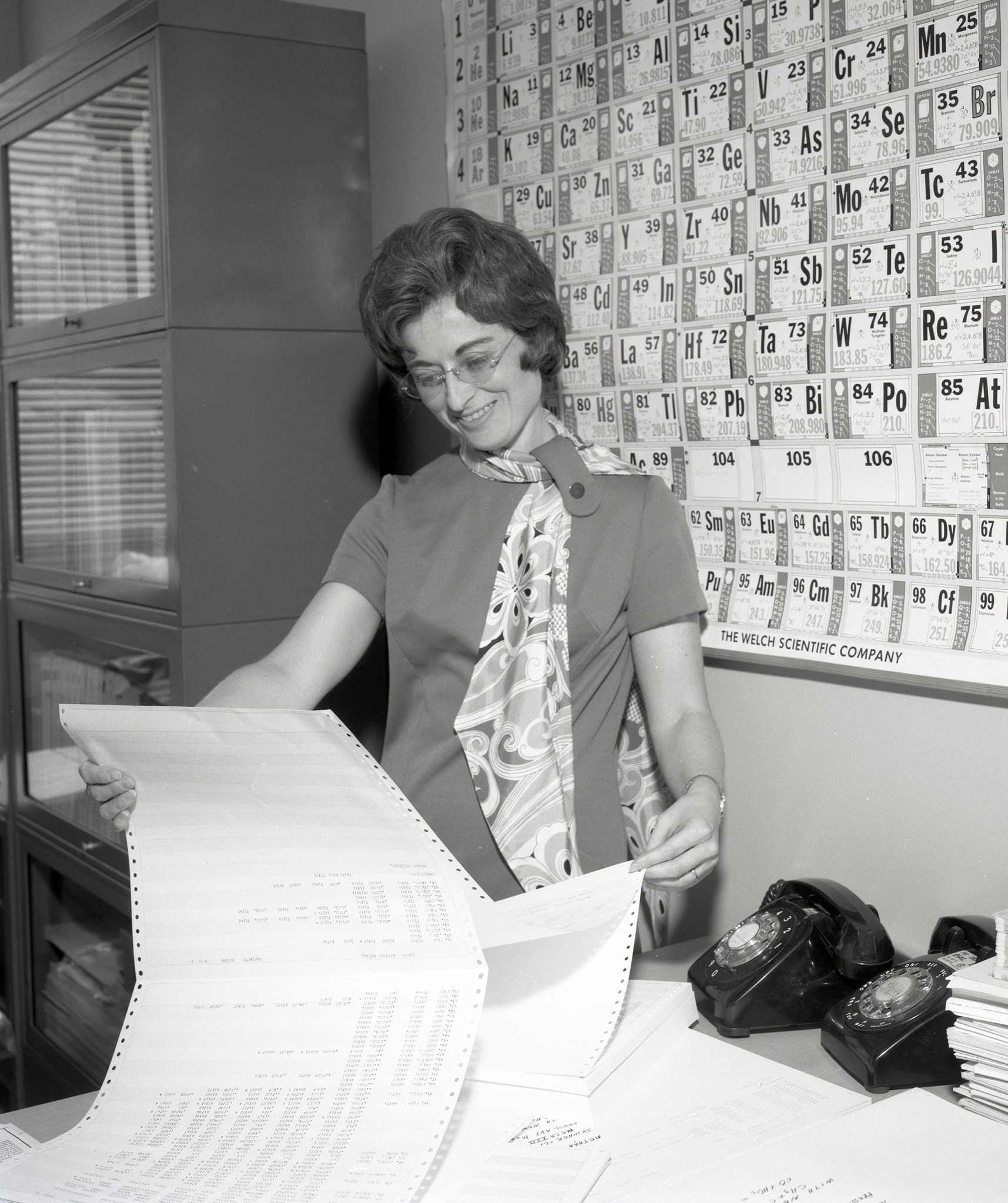 Woman reading computer print out.