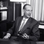Man seated in office.
