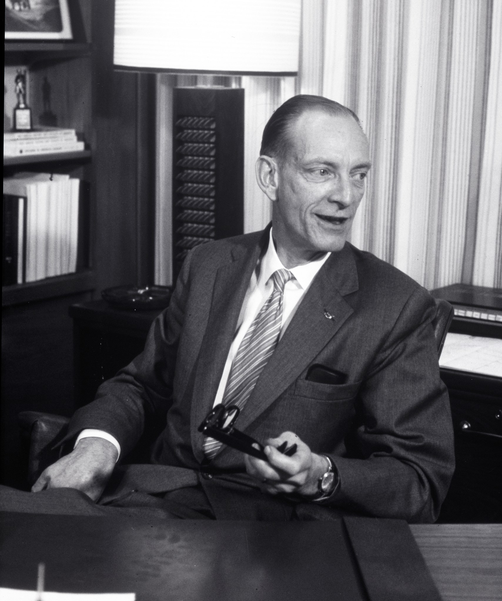 Man seated in office.