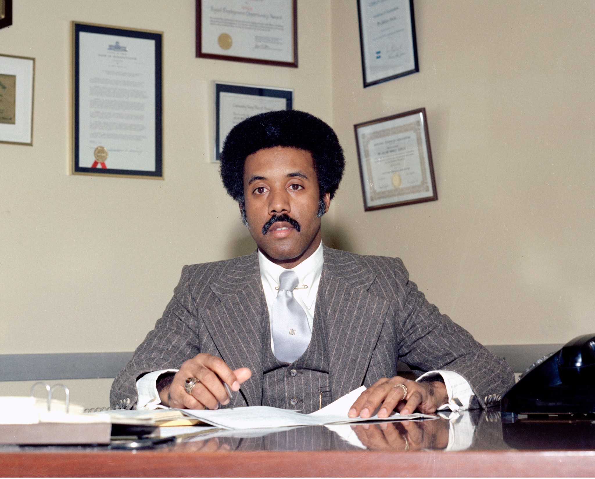 Man seated at office desk.