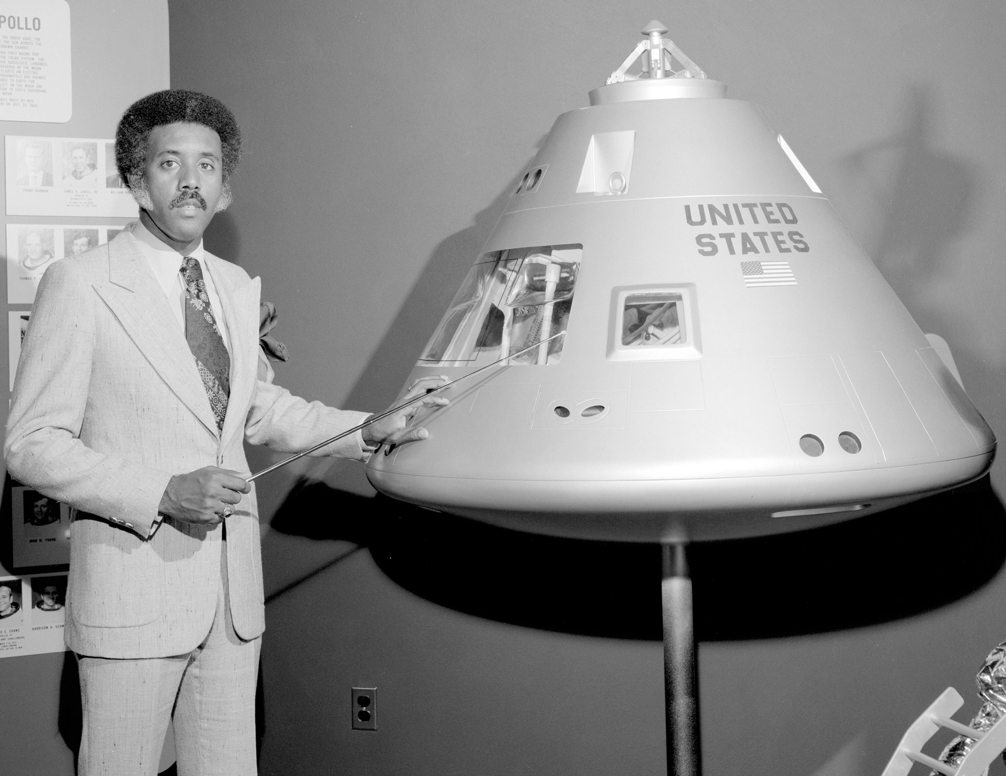 Man pointing to spacecraft model.