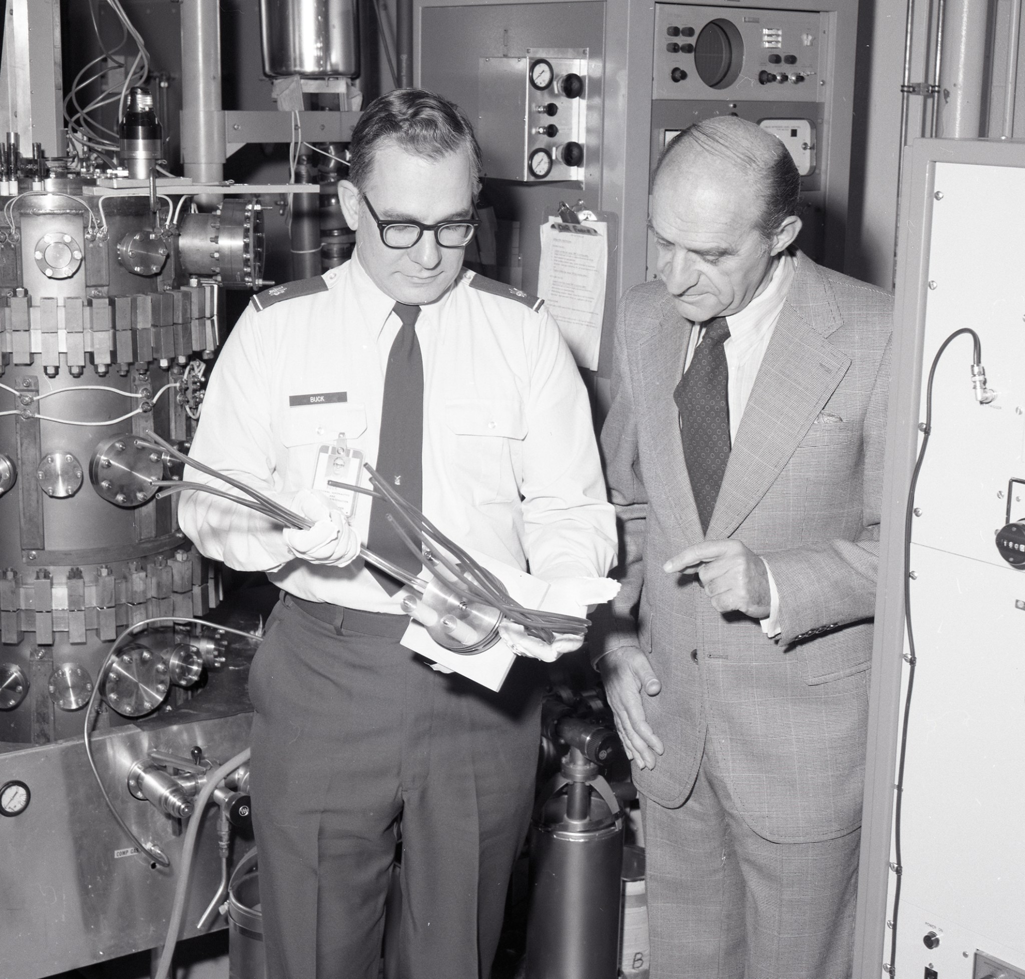 Two men reading document.