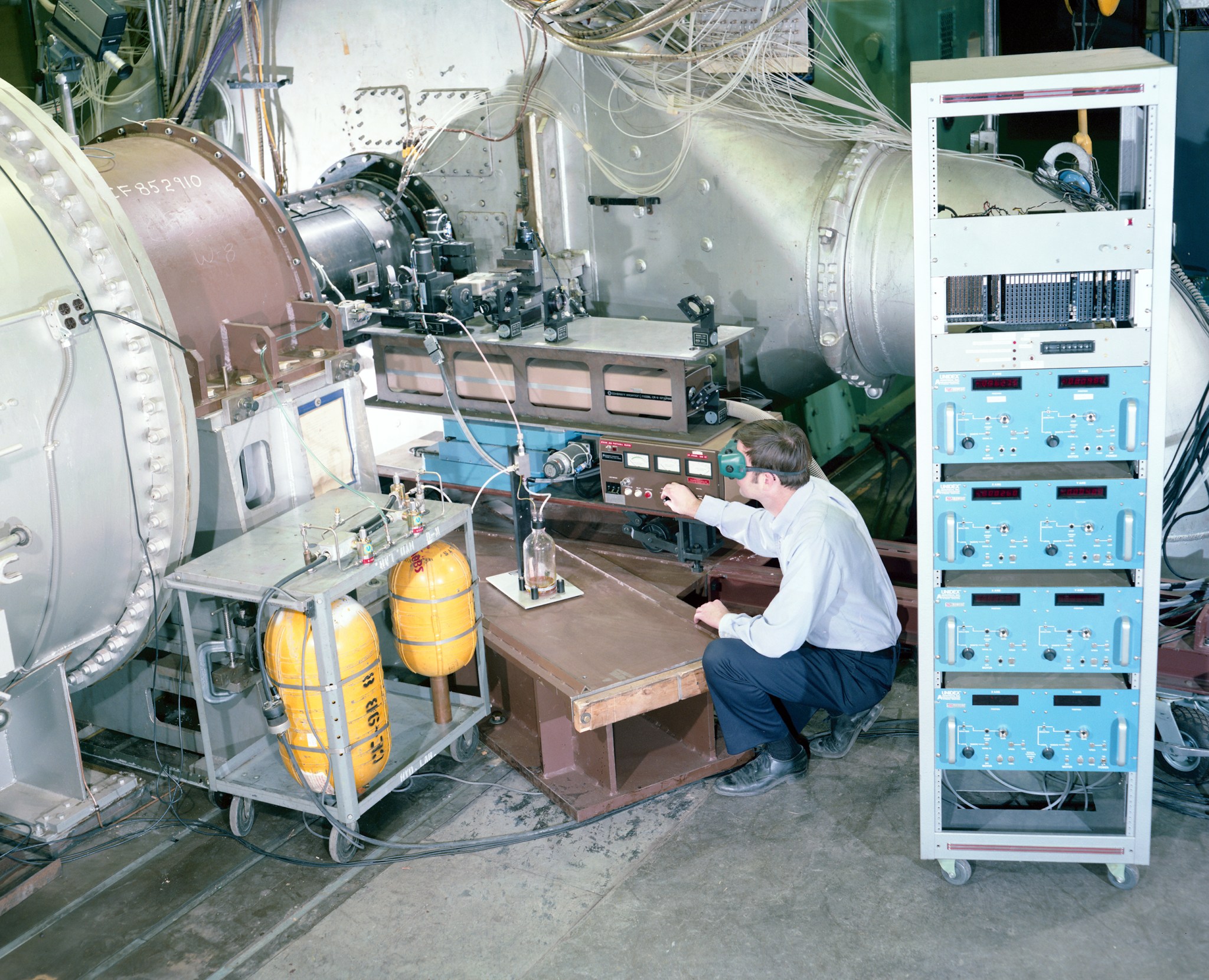 Man bending to look at equipment.