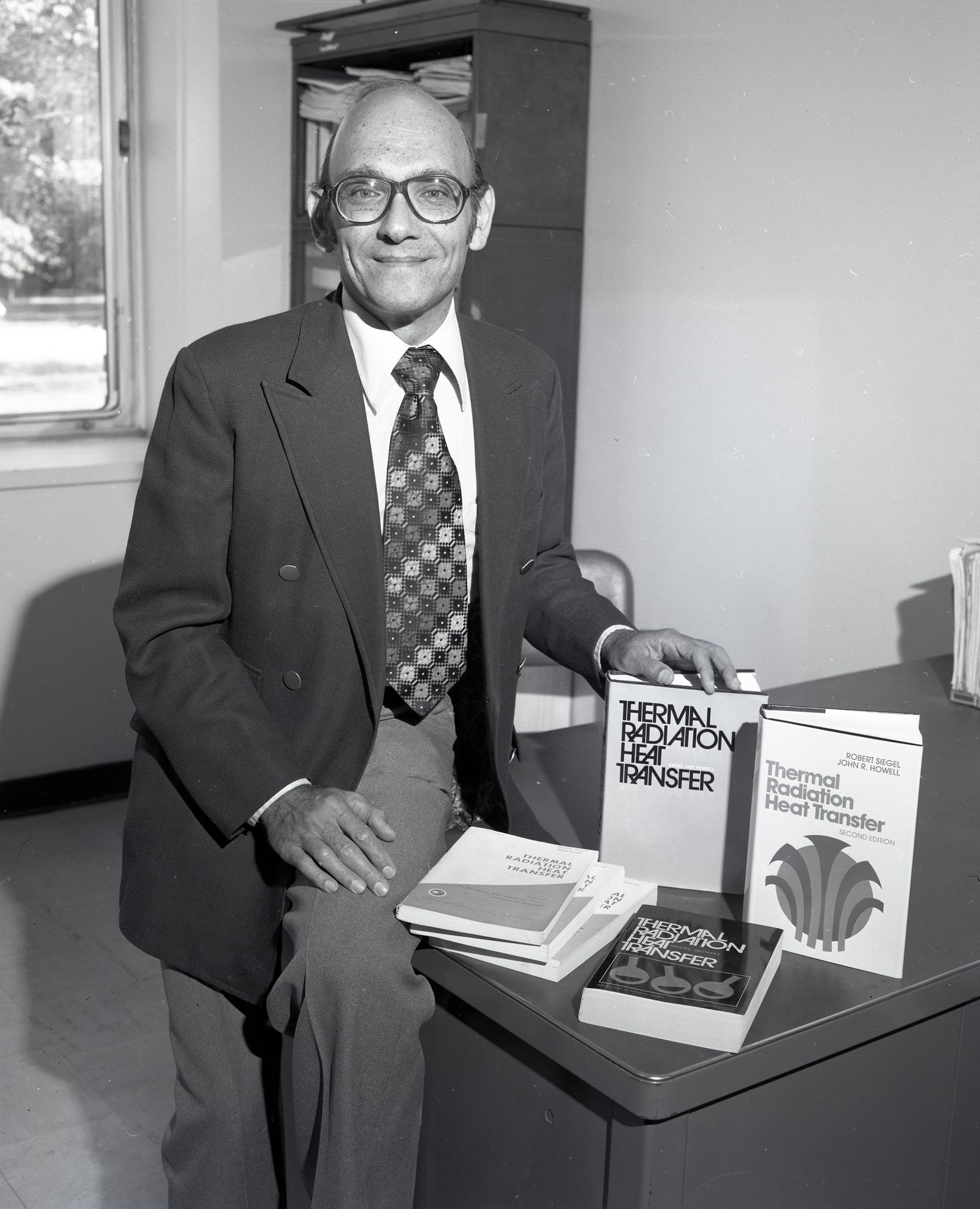 Man displaying books.