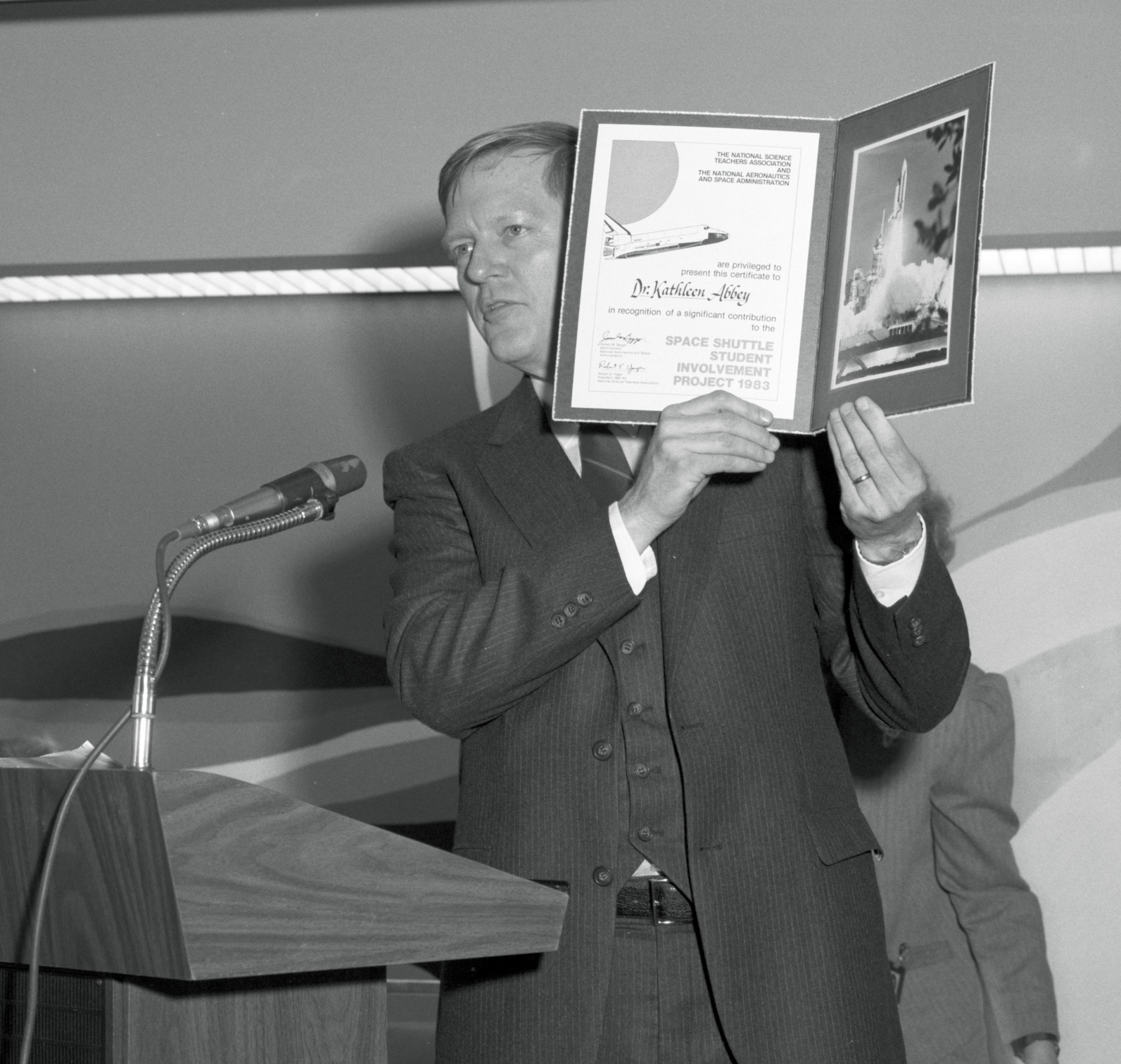 Man holding up book.