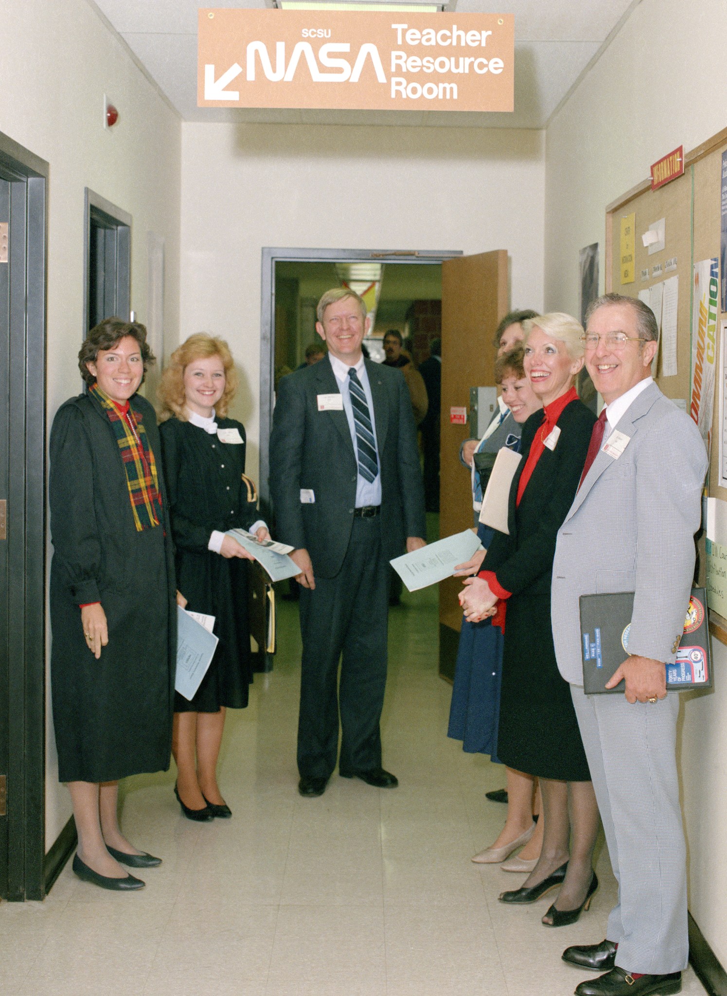 Group of teachers standing in hallway.