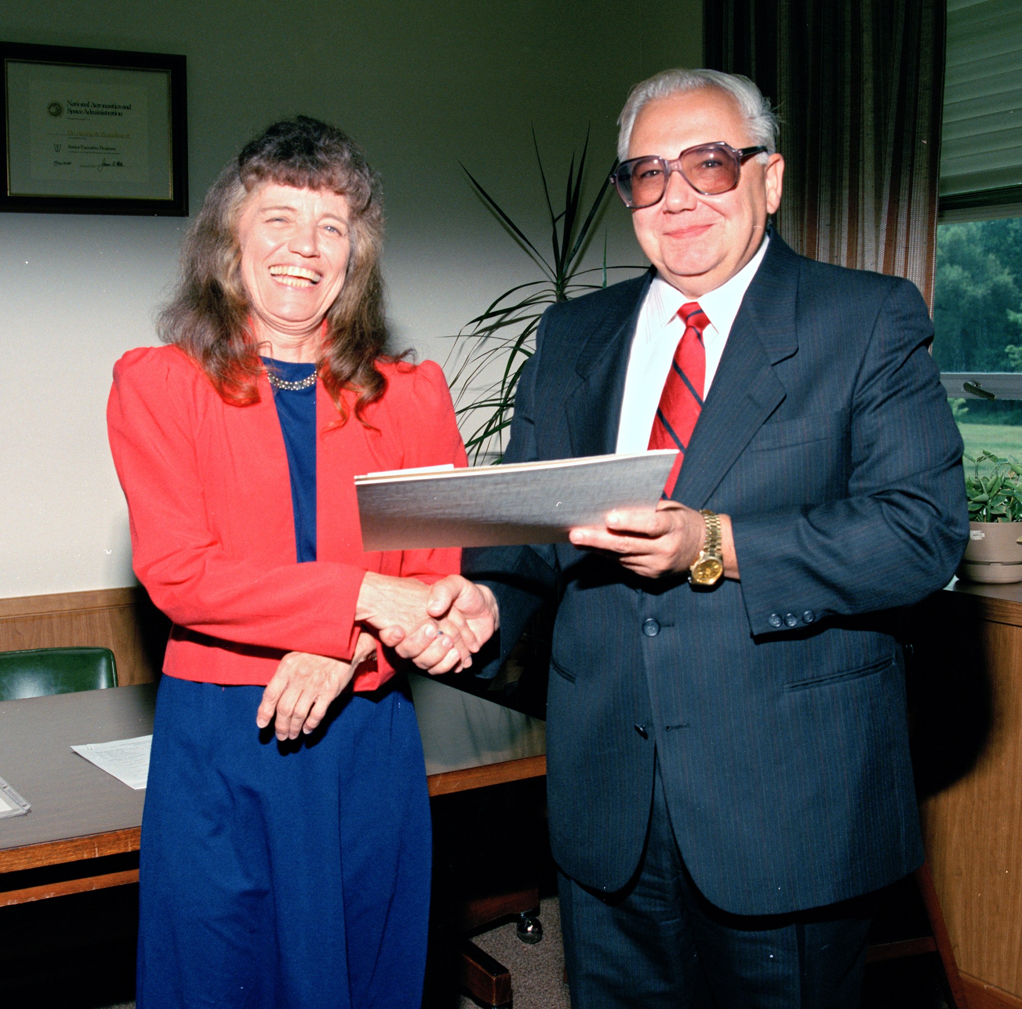 Woman and man shaking hands.