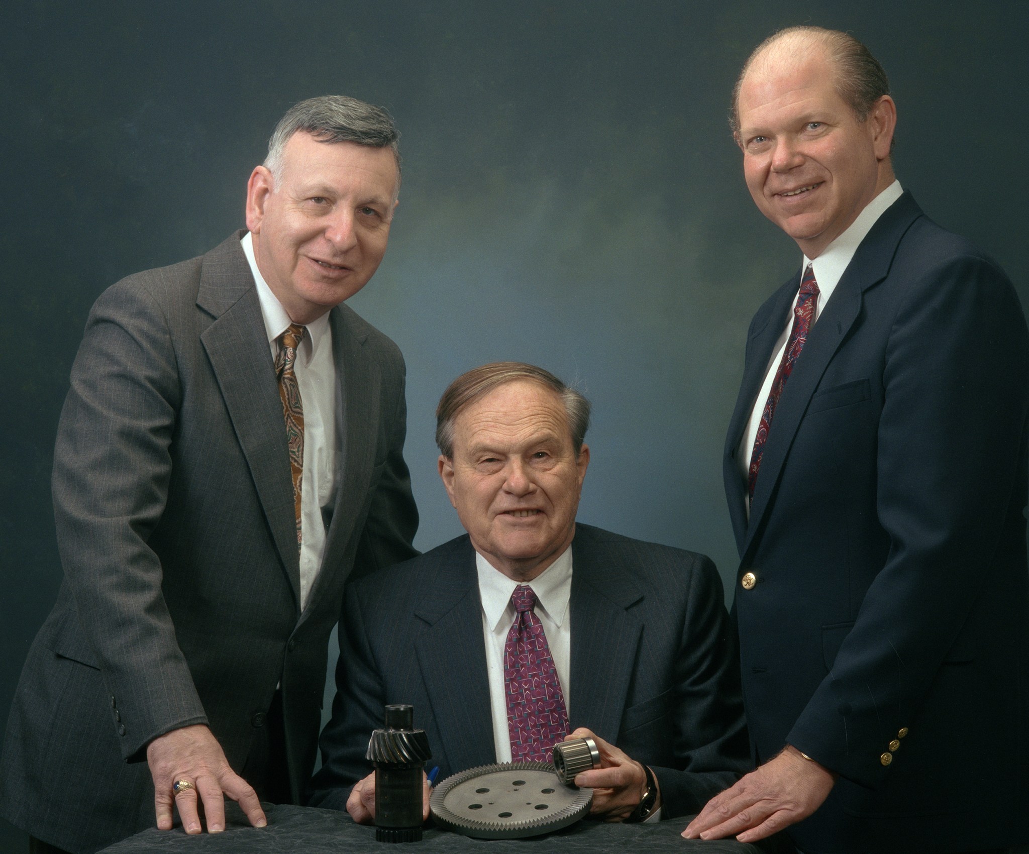 Three men posing for photograph.
