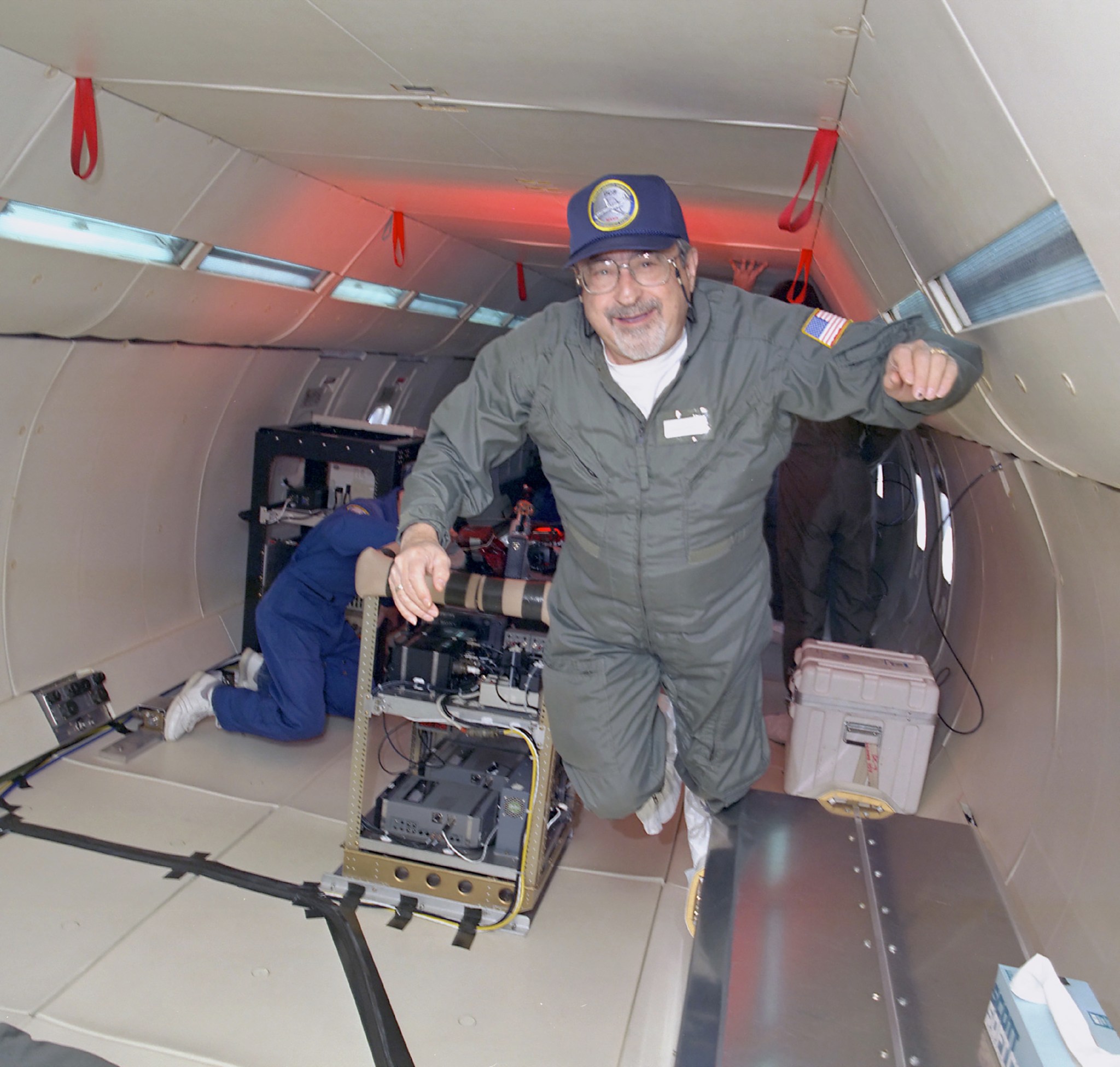 Man in floating in rear of airplane.