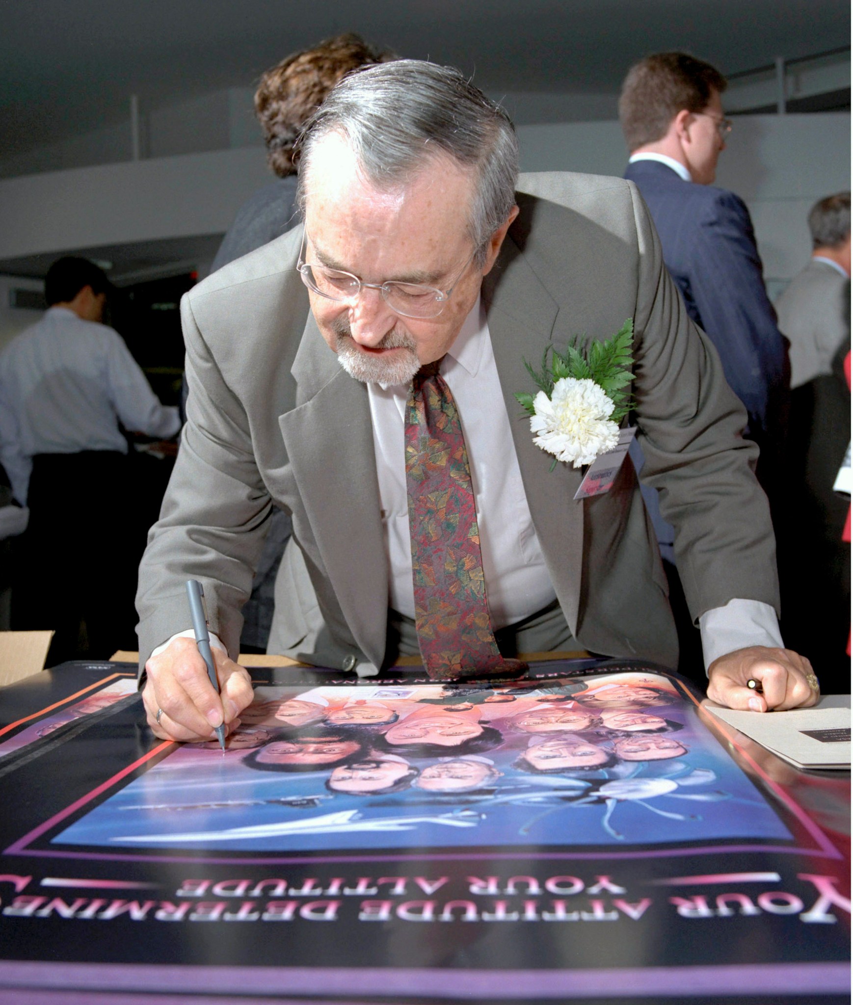 Man autographing a poster.