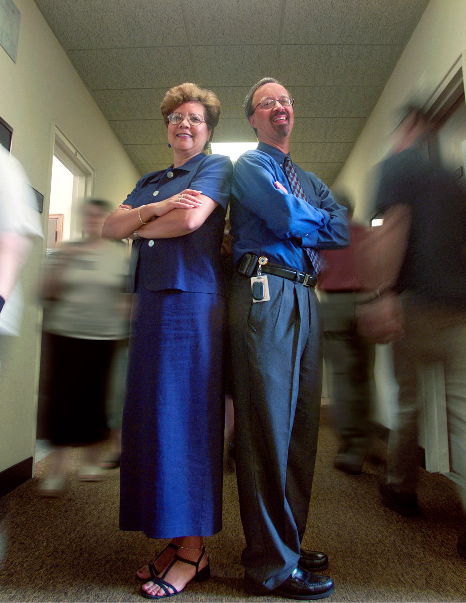 Man and woman standing in hallway.
