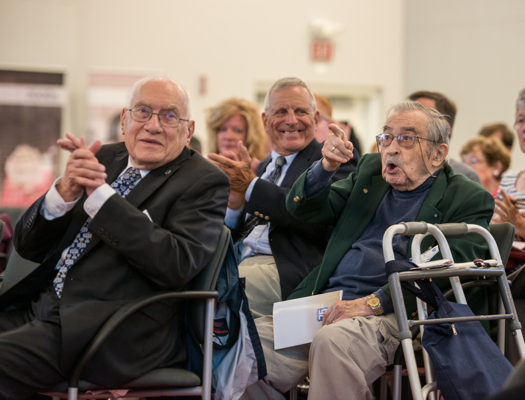 Seated audience members applauding.