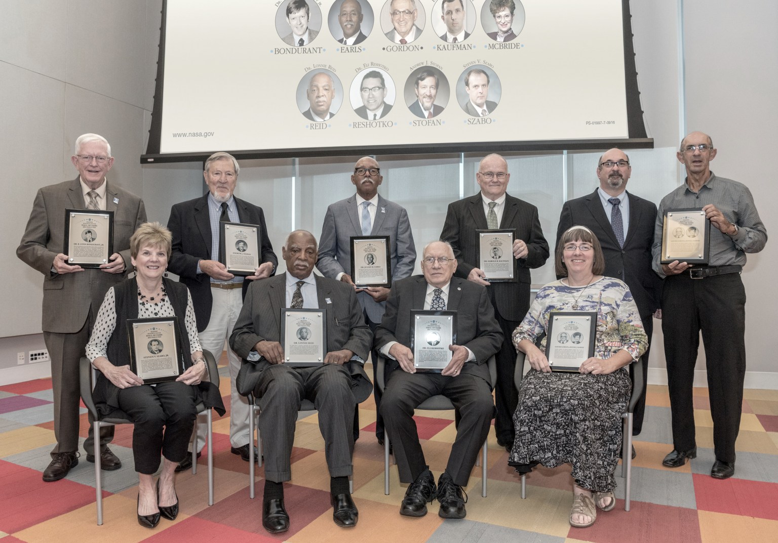 Group of people holding awards.