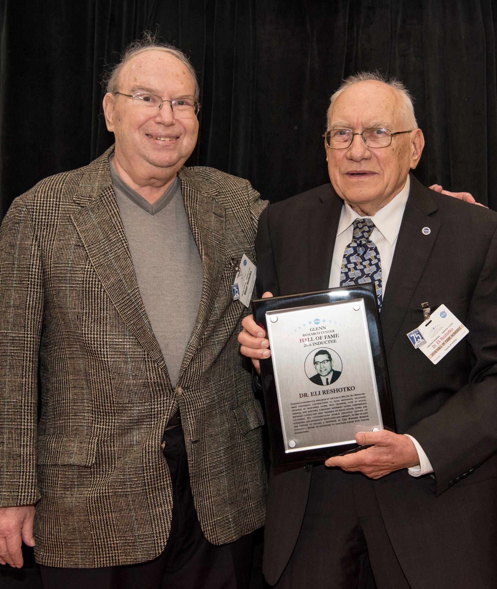 Two men standing with plaque.