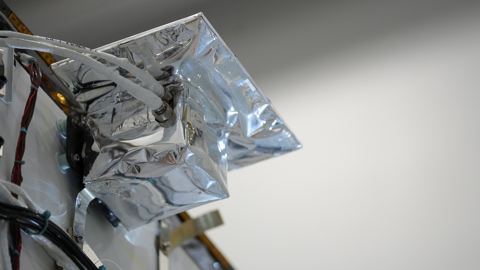 An close up image of the Lunar Node-1 payload covered in a silver wrapping to protect it in space.