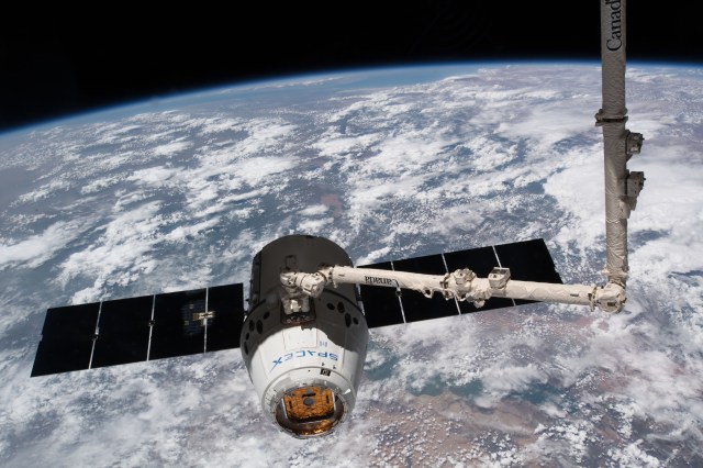 The SpaceX Dragon resupply ship is pictured just moments after Japan Aerospace Exploration Agency astronaut Norishige Kanai commanded the 57.7-foot-long Canadarm2 robotic arm to reach out and capture the commercial space freighter.