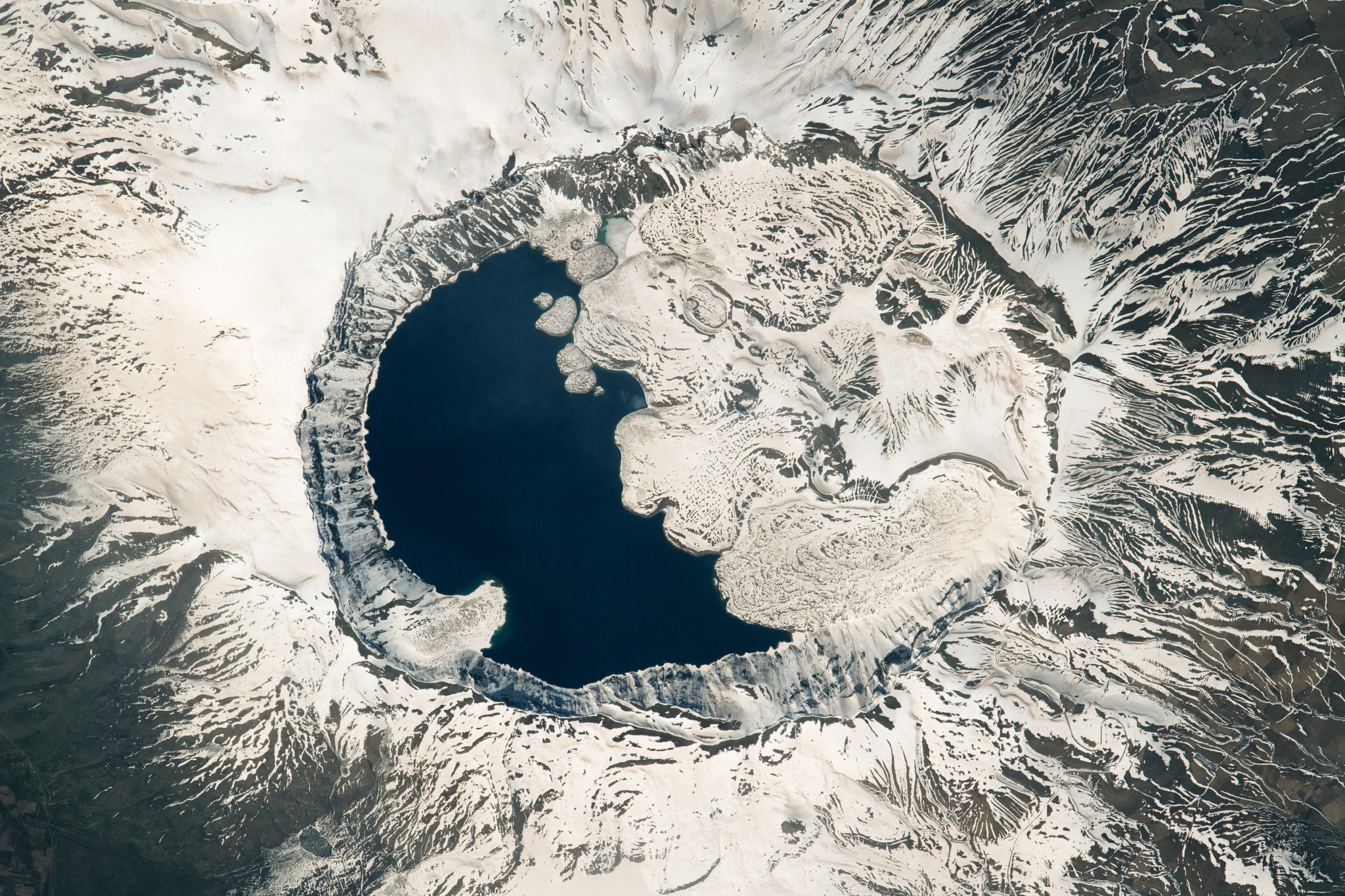 An astronaut aboard the International Space Station captured this photo of the snow-covered caldera of the Nemrut volcano in eastern Türkiye, along the western shore of Lake Van.