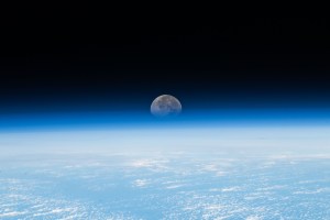 Earth's atmosphere refract's the Moon's light as it sets below the horizon in this photograph from the International Space Station while orbiting 260 miles above the Pacific Ocean.