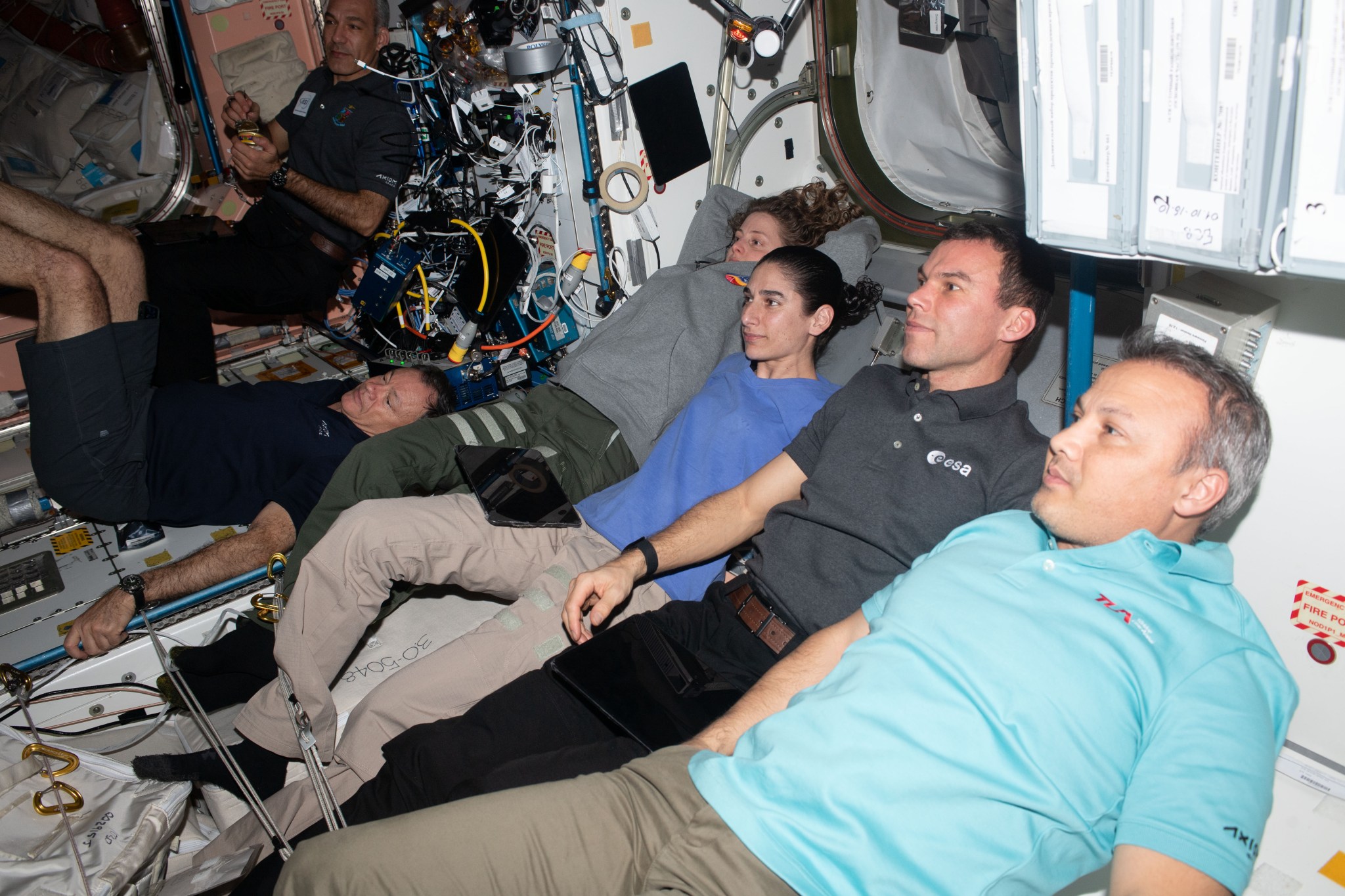 Members of the Axiom Mission 3 (Ax-3) and Expedition 70 crews join each other for movie night inside the International Space Station's Harmony module. From left are, Ax-3 Pilot Walter Villadei; Ax-3 Commander Michael López-Alegría; Expedition 70 Flight Engineers Loral O'Hara and Jasmin Moghbeli, both from NASA; and Ax-3 Mission Specialists Marcus Wandt and Alper Gezeravcı.