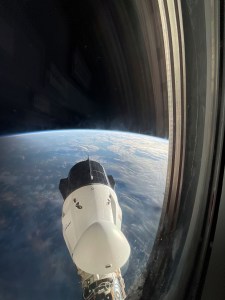 The SpaceX Dragon Freedom spacecraft is pictured from a window aboard the SpaceX Dragon Endurance spacecraft. Both spacecraft are docked to ports on the International Space Station's Harmony module. Freedom is seen moments before undocking from Harmony's forward port with the Axiom Mission 3 crew aboard.