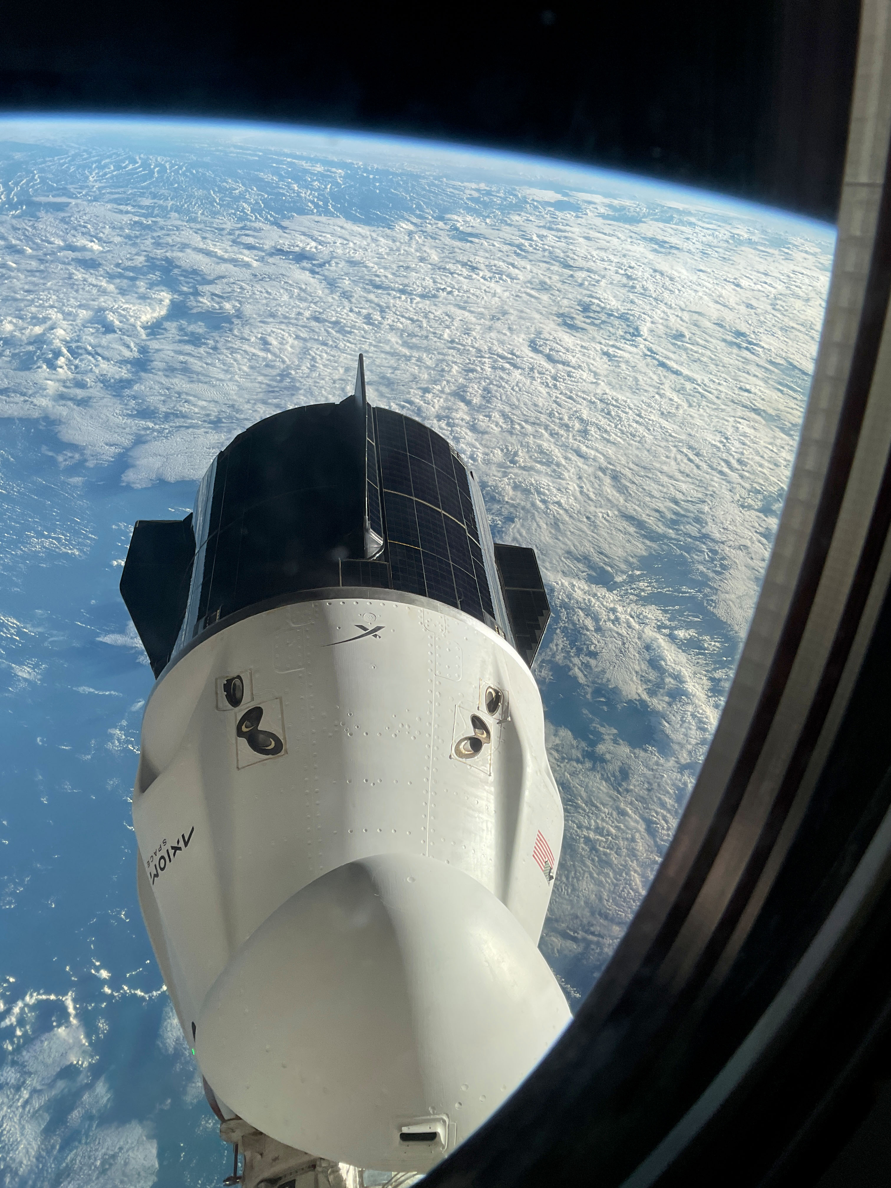 The SpaceX Dragon Freedom spacecraft is pictured from a window aboard the SpaceX Dragon Endurance spacecraft. Both spacecraft are docked to ports on the International Space Station's Harmony module. Freedom is seen moments before undocking from Harmony's forward port with the Axiom Mission 3 crew aboard.